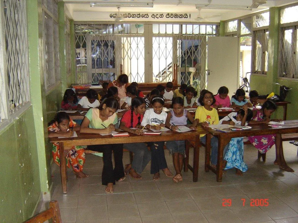Children writing at desks in the Colombo Centre classroom