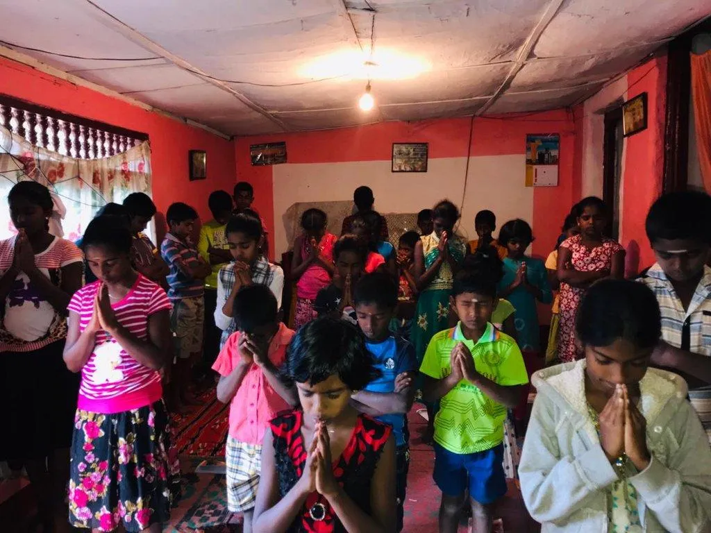 Children praying together at Kidz Club